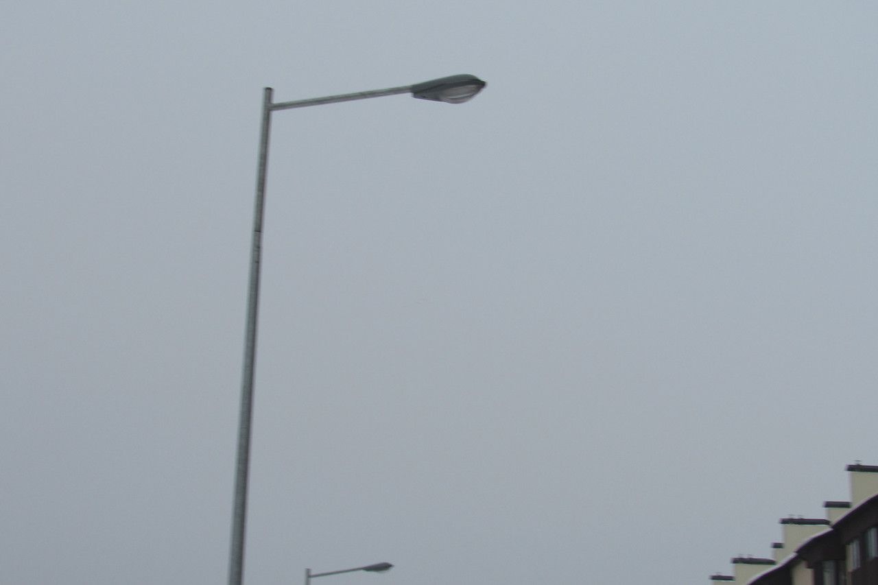 Single-arm bracket for mounting one luminaire on a lighting pole.